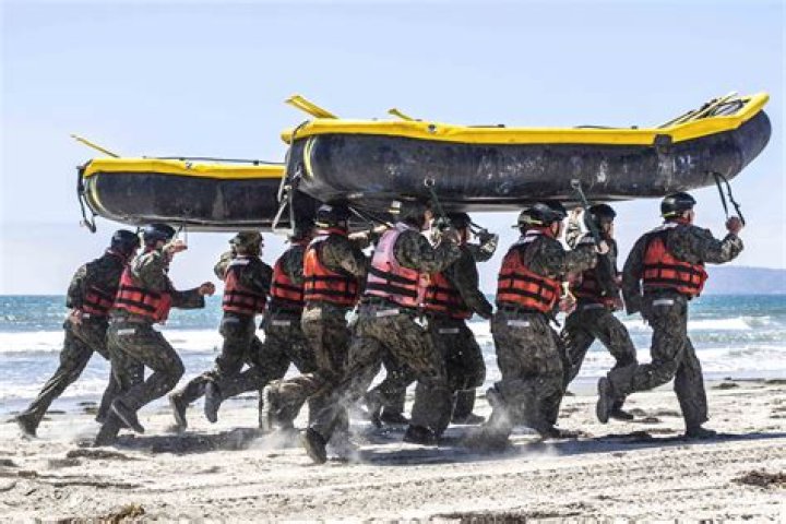 How much weight do Navy SEALs carry?