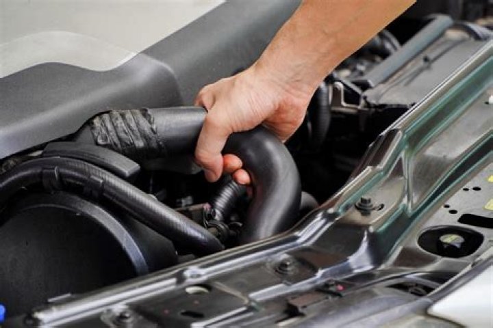 Should my upper radiator hose be hard when engine is warm?